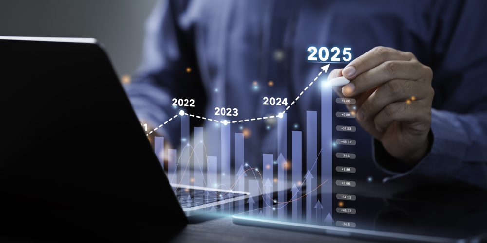 Hand holding a pen drawing pretend stocks from a computer