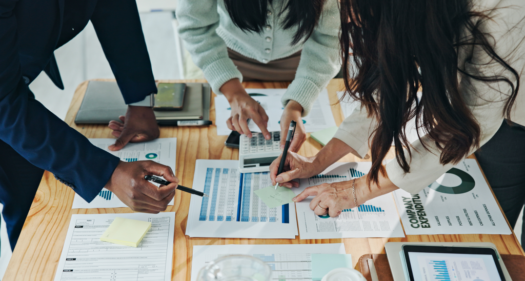 Team reviewing financial reports and budgeting documents to improve financial planning