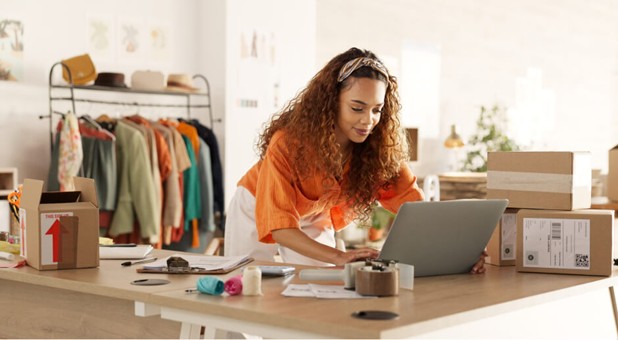 Woman working on a laptop in a clothing store